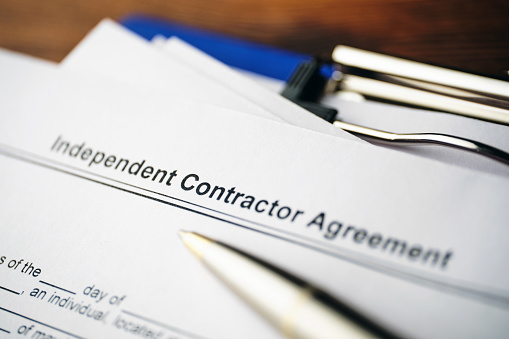 Legal document Independent Contractor Agreement on paper close up.