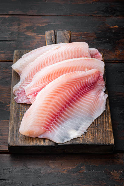istock Raw white fish fillet, on old wooden table 1292209386
