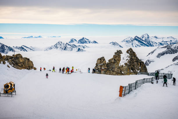 Hintertux, Austria - February 25.02.2020: On mountain top on glacier in Hintertux in Zillertal. Some persons with skis and snowboards in front.