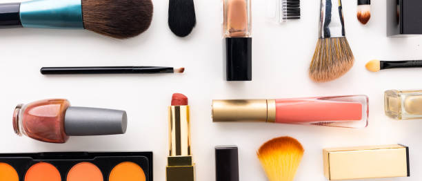 istock Plenty of makeup on the white table with eyelash brush, eye shadow, lipstick. 1292219727