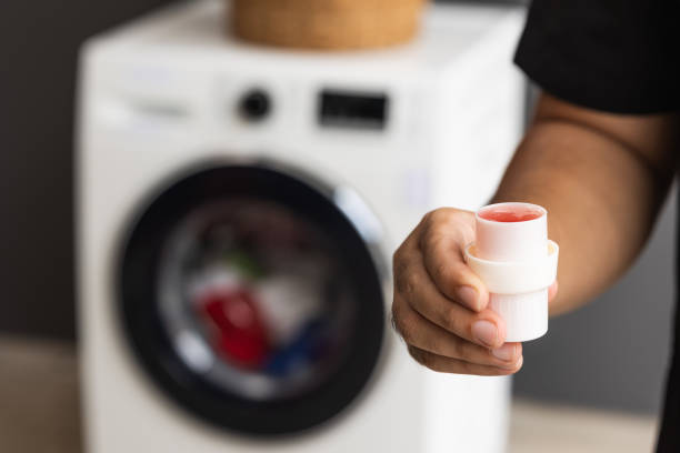 istock Pour some laundry detergent on the clothes and put it in the was 1292219814
