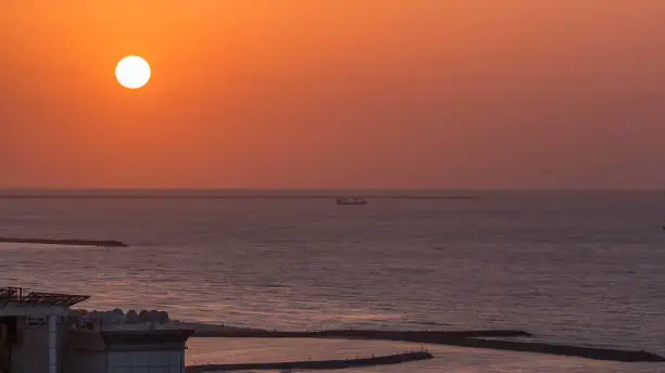 Photo of Sunset in Ajman from rooftop timelapse. Ajman is the capital of the emirate of Ajman in the United Arab Emirates