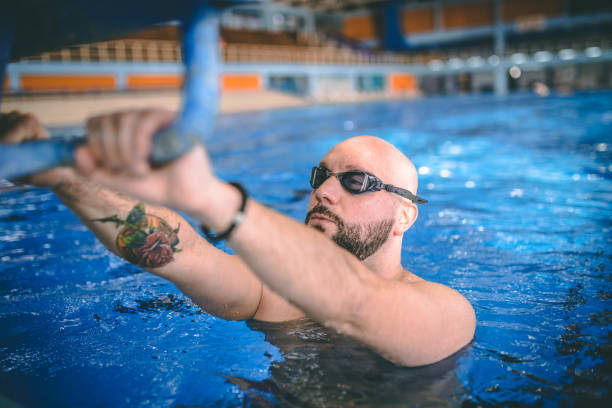 istock Young muscular man in swimming pool 1292221841