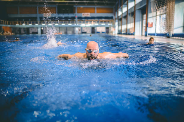 istock Handsome swimmer in goggles exercising in swimming pool 1292222699
