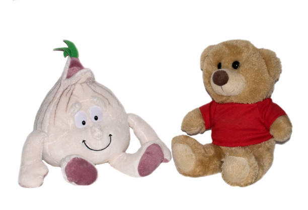 istock Stuffed toys teddy bear and onion on a white background 1292222927