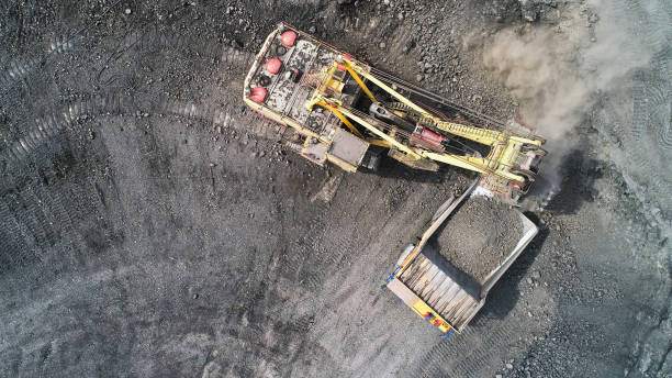 istock Cable excavator loads overburden from the body of a mining truck. 1292223021