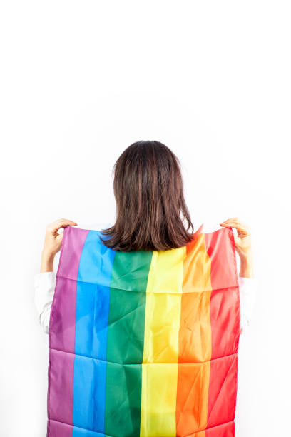 istock Woman with a rainbow flag on a white background.Concept lgtb 1292224959