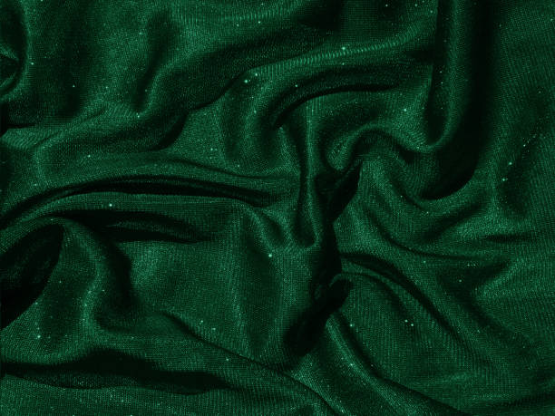 istock Shiny green emerald crumpled fabric texture. Elegant cloth background 1292225597