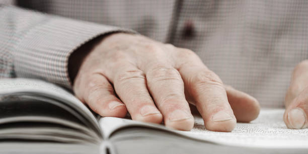 istock adult man reads interesting book at table in light room 1292226689