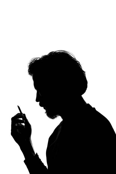istock Monochrome silhouette of a smoking man 1292227803