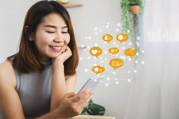 istock happy Asian woman using smart phone sharing, chatting with friends 1292228487
