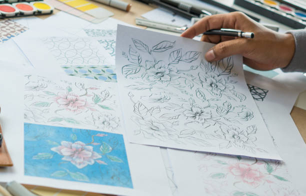 istock Designer designing drawing sketch pattern geometric flower seamless wallpaper fabric textile fashion industry. artistic design studio. 1292228514