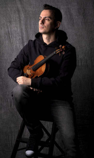 istock Portrait of violinist on dark background , 1292228556