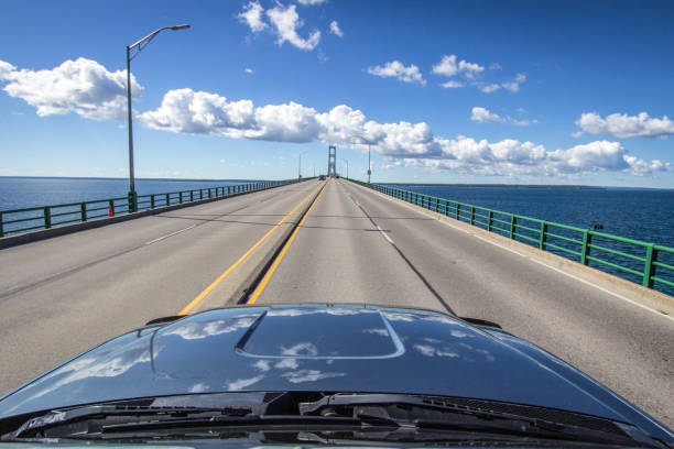 Driving Across The Mackinaw Bridge In Michigan The Mackinaw Bridge connects the Upper and Lower Peninsula of Michigan. A notable landmark on Interstate 75, it is one of the longest suspension bridges in the world. car point of view stock pictures, royalty-free photos & images