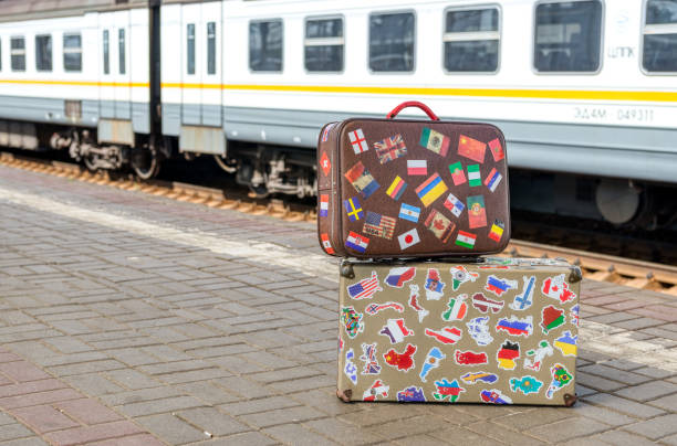 Forgotten traveler's suitcase on a passenger platform. Empty train station.