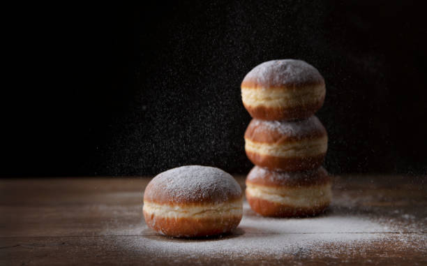 istock European donut sprinkled with powdered sugar on black background. 1292232561