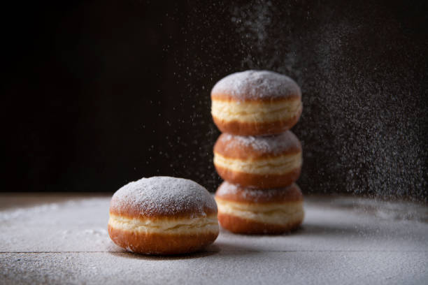 Berliner krapfen filled with marmelade sprinkled with white sugar. Traditional Mardi Gras or Fat Tuesday doughnut.