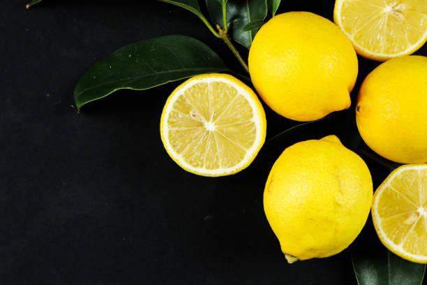 istock Group of lemons with leaves, isolated on background 1292233275