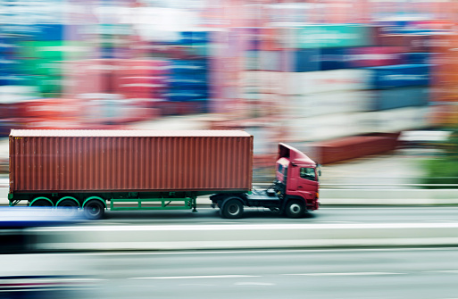 Red truck leaving the harbor.