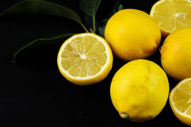 istock Group of lemons with leaves, isolated on background 1292233370
