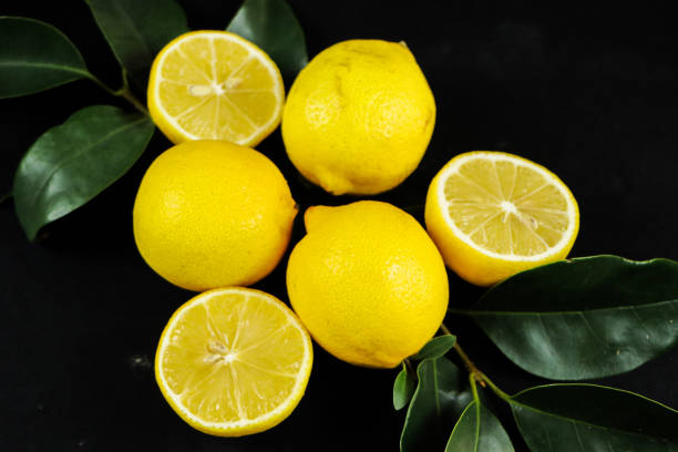 istock Group of lemons with leaves, isolated on background 1292233393