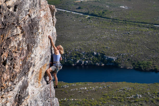 istock Active senior woman climbing a rock face 1292240978