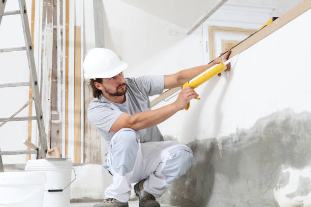 istock construction worker plasterer man uses caulking gun in building site of home renovation with tools and building materials on the floor 1292240985