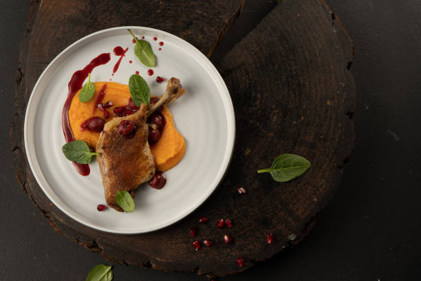 istock Duck confit. Grilled duck leg with mashed potatoes or sweet potatoes and cherry sauce. 1292242769