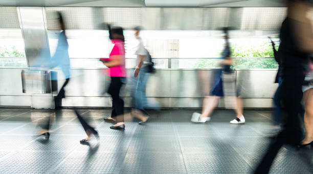 istock Blurred people walking in a corridor 1292243148