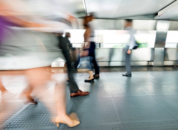 istock Blurred people walking in a corridor 1292243283