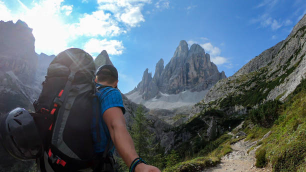 istock Oberbachernspitze - A man with big backpack taking a selfie while hiking along a narrow pathway in Italian Dolomites 1292243292