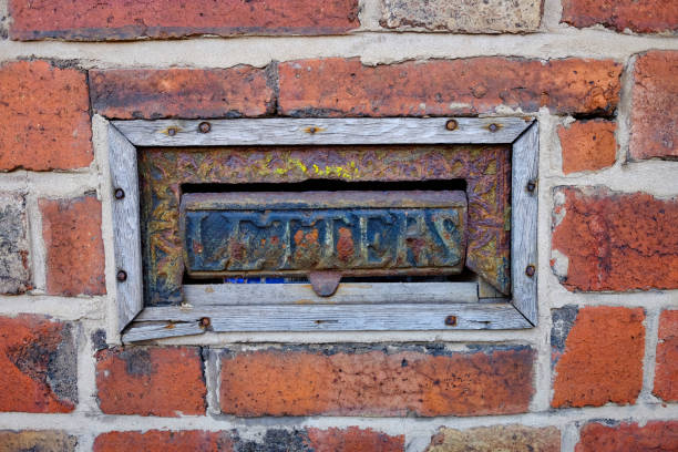 istock Old metal letterbox in brick wall, Leeds, west yorkshire, England, Britain 1292243621
