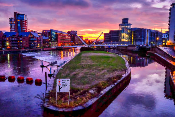 Colorful sunrise over river and canal in city, Leeds, West Yorkshire, England, Britain Colourful sunrise over Leeds Dock leeds photos stock pictures, royalty-free photos & images