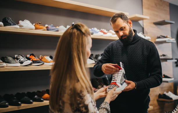 istock Customer and seller in a shoe store 1292243673