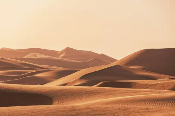 Abu Dhabi Empty Quarter Sunset over majestic Desert Sand Dunes. Empty Sea of Sand in the Rub' al Khali Desert under dusk twilight skyscape. Desert Sand Dunes close to the border of Saudi Arabia and the United Arab Emirates. Emirate of Abu Dhabi, United Arab Emirates, Middle East, Persian Gulf Countries