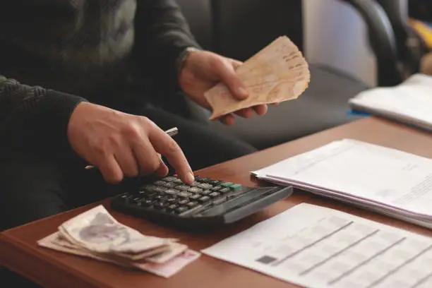 Photo of man calculates income and expense in his business