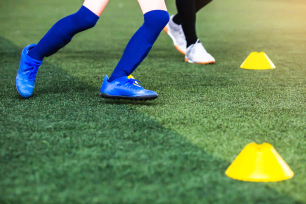 istock Selective focus to boy soccer player is  jogging with blurry cone marker 1292245646