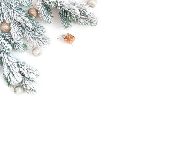 Christmas composition. Snow-covered fir branches, golden balls and mini gifts are on a white background. New Year card. Flat lay, top view, copy space. stock photo