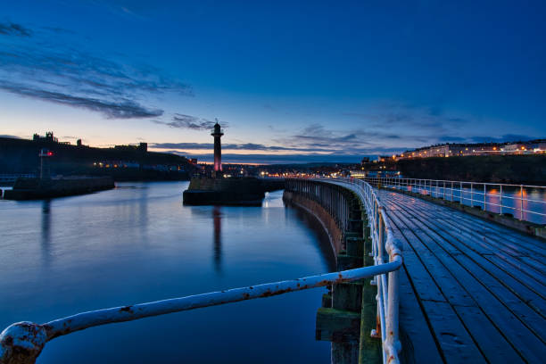 istock Whitby lighthouse and abbey at blue hour, Whitby, North Yorkshire, England, Britain 1292247638
