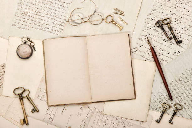 istock Open journal book writing items Vintage paper background 1292248348