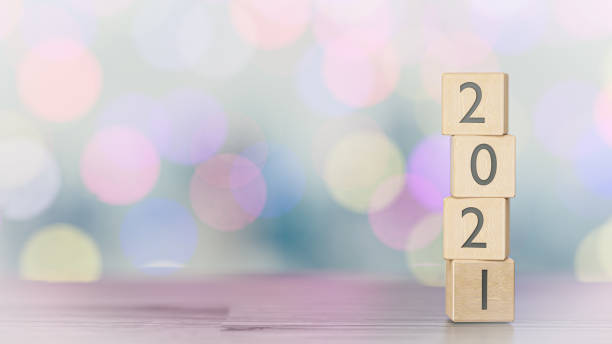 istock Wood blocks with the transition from year 2021 on a bokeh background. 3D rendering. 1292248706