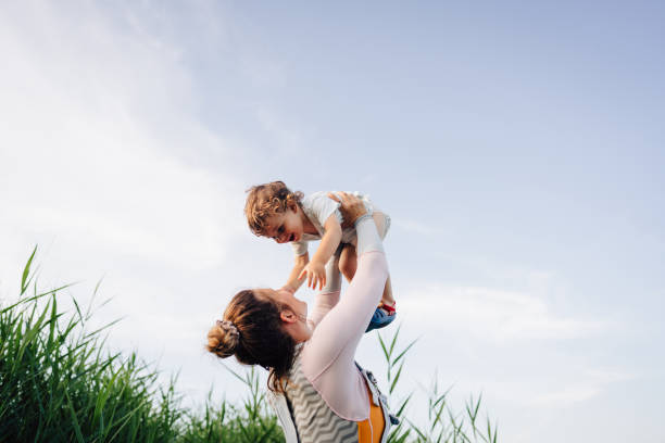 Summer with a toddler Photo of a young mother spending summer days by the lake with her little boy, who is still a toddler one kid only stock pictures, royalty-free photos & images