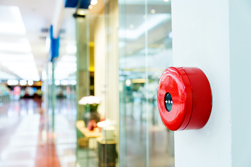 Fire alarm on wall of shopping mall.