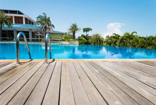 istock Swimming pool with ladder under blue sky 1292250081