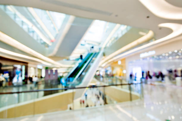 blurred background of shopping mall - escalator people city blurred motion imagens e fotografias de stock