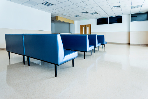 Blue bench in hospital waiting room.