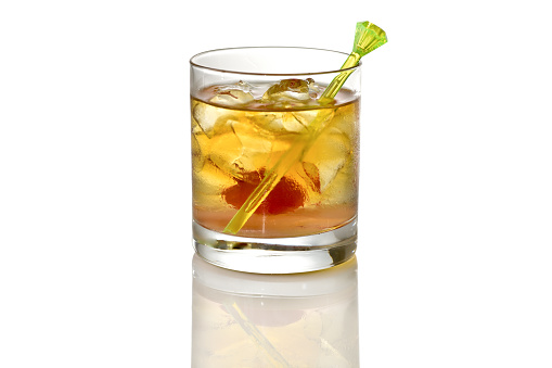 Old fashioned cocktail without orange slice whiskey glass on white background with reflection