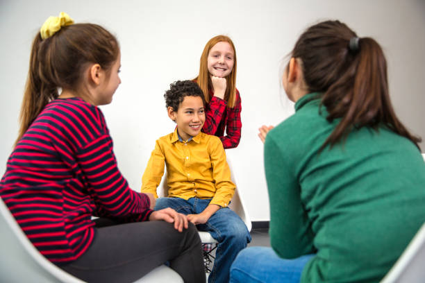 istock Group of children smiling and talking 1292255319