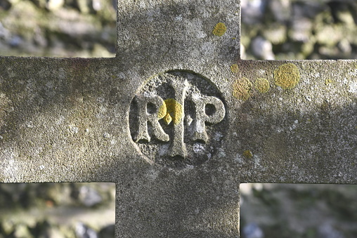 Close-up of cross on old gravestone