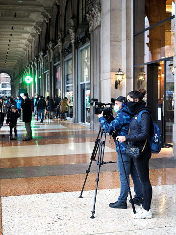 Italian broadcasting company RAI News crew shooting last Sunday before Christmas shoppers in Piazza Duomo from Galleria, Milan downtown, under Covid-19 red zone decree, December 2020